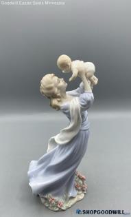 Valencia Collection Mother Holding Up Her Baby Wearing A Blue Dress Figurine