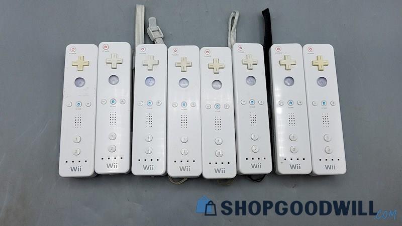 B) Lot of 8 Nintendo Wii Remotes Wiimotes Controllers - Powers On