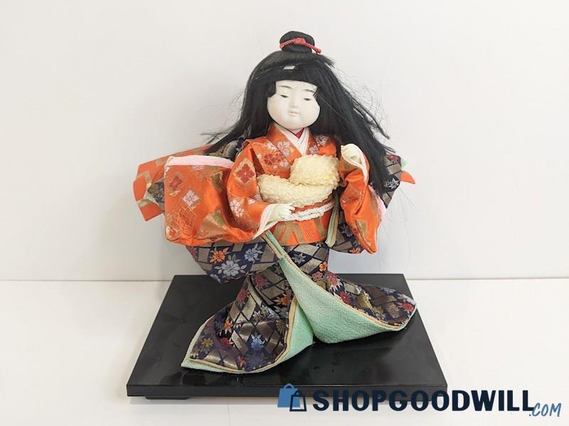 Appears to Be Japanese Girl Doll Figurine in Kimono Outfit on Wooden Platform 